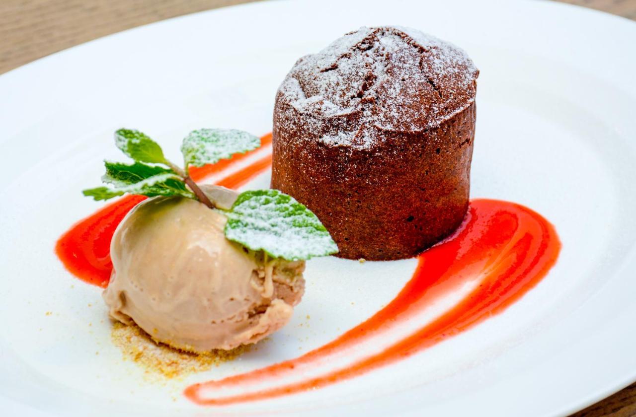 The Merchant House Manama Exterior photo A chocolate soufflé with ice cream